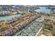 Aerial view of a townhouse community featuring tennis courts and pool with waterway views at 442 Sandy Hook Rd, Treasure Island, FL 33706