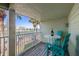 Cozy balcony features outdoor seating with scenic views of tennis courts and lush palm trees at 442 Sandy Hook Rd, Treasure Island, FL 33706
