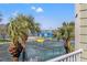 Balcony with a view of palm trees and tennis courts, perfect for outdoor relaxation and entertainment at 442 Sandy Hook Rd, Treasure Island, FL 33706