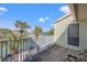 Scenic balcony view showcasing palm trees and tennis courts, providing an active and engaging lifestyle at 442 Sandy Hook Rd, Treasure Island, FL 33706