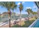 Balcony view overlooking a vibrant tennis center, marina, and waterfront at 442 Sandy Hook Rd, Treasure Island, FL 33706