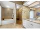 A well-lit bathroom shows a soaking tub and tiled walk-in shower at 442 Sandy Hook Rd, Treasure Island, FL 33706