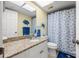 Decorated bathroom featuring a granite vanity, and seashell themed shower curtain at 442 Sandy Hook Rd, Treasure Island, FL 33706