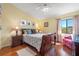 Sunlit bedroom with hardwood floors, a queen-sized bed, and neutral walls creating a relaxing atmosphere at 442 Sandy Hook Rd, Treasure Island, FL 33706