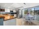 Bright breakfast nook with tiled floors and views of the lush surroundings at 442 Sandy Hook Rd, Treasure Island, FL 33706