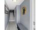 Hallway with stairs, bench, and neutral colors, creating an inviting entrance to the home at 442 Sandy Hook Rd, Treasure Island, FL 33706