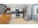 Bright kitchen features stainless steel appliances and light-colored countertops at 442 Sandy Hook Rd, Treasure Island, FL 33706