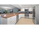 Bright kitchen featuring white cabinets, stainless steel appliances, and tile floors, ideal for culinary enthusiasts at 442 Sandy Hook Rd, Treasure Island, FL 33706