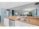 Kitchen view of the living room with a breakfast bar and stainless steel appliances at 442 Sandy Hook Rd, Treasure Island, FL 33706