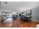 Expansive living room featuring fireplace, hardwood floors and a dining area at 442 Sandy Hook Rd, Treasure Island, FL 33706