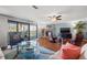 Bright living room with hardwood floors, a fireplace, and large sliding glass doors to a patio at 442 Sandy Hook Rd, Treasure Island, FL 33706