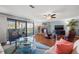 Open concept living room with fireplace, hardwood flooring, and view to outside balcony at 442 Sandy Hook Rd, Treasure Island, FL 33706