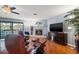 Inviting living room with a cozy fireplace, hardwood floors, and sliding doors to the balcony at 442 Sandy Hook Rd, Treasure Island, FL 33706