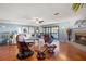 Spacious living room featuring a fireplace, hardwood floors, and balcony access at 442 Sandy Hook Rd, Treasure Island, FL 33706