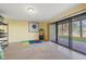 Bright room with tile flooring, a sliding glass door and some shelving at 442 Sandy Hook Rd, Treasure Island, FL 33706