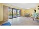 Bright room with tile flooring, yellow walls and a sliding glass door at 442 Sandy Hook Rd, Treasure Island, FL 33706