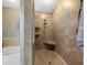 Walk-in shower with tile surround, a built-in bench, and dual shower heads at 442 Sandy Hook Rd, Treasure Island, FL 33706