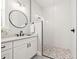 Bright bathroom with white vanity, framed mirror, and a step-in shower at 445 29Th N Ave, St Petersburg, FL 33704