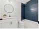 Updated bathroom featuring a vanity with white cabinets and a shower with stylish blue tile at 445 29Th N Ave, St Petersburg, FL 33704