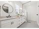 Modern bathroom with double sinks, quartz countertops, and frameless glass shower at 445 29Th N Ave, St Petersburg, FL 33704