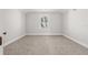 Bright bedroom with neutral carpet and walls, featuring a window providing natural light at 445 29Th N Ave, St Petersburg, FL 33704