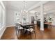 Stylish dining room featuring hardwood floors, modern chandelier, and open access to kitchen area at 445 29Th N Ave, St Petersburg, FL 33704