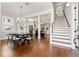 Bright, open-concept view of the dining room, stairway, and kitchen, featuring hardwood floors and modern fixtures at 445 29Th N Ave, St Petersburg, FL 33704