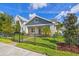 Charming home exterior with manicured lawn, a sleek black fence, and mature trees enhancing curb appeal at 445 29Th N Ave, St Petersburg, FL 33704