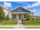 Charming home featuring stylish curb appeal, complemented by a lush lawn and decorative black metal fence at 445 29Th N Ave, St Petersburg, FL 33704