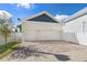 Well-maintained home exterior with a two-car garage and a paver driveway, showcasing curb appeal at 445 29Th N Ave, St Petersburg, FL 33704