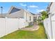 Charming home exterior with manicured lawn and a stylish white fence for added privacy at 445 29Th N Ave, St Petersburg, FL 33704
