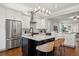 Elegant kitchen featuring white cabinetry, stainless steel appliances, a dark wood island, and barstool seating at 445 29Th N Ave, St Petersburg, FL 33704