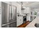 Kitchen boasting stainless steel appliances, white cabinets, granite countertops, and tile backsplash at 445 29Th N Ave, St Petersburg, FL 33704