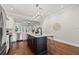 Open kitchen with an island, stainless appliances, hardwood floors, and a modern lighting fixture at 445 29Th N Ave, St Petersburg, FL 33704