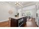 Modern kitchen island with white countertops, dark wood cabinets, and sleek stainless steel appliances at 445 29Th N Ave, St Petersburg, FL 33704