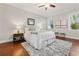 Well-lit main bedroom with natural light, hardwood floors, and a cozy queen bed at 445 29Th N Ave, St Petersburg, FL 33704