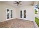 Covered outdoor patio with neutral brick flooring and views of the backyard and lush landscaping at 445 29Th N Ave, St Petersburg, FL 33704