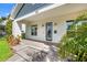 Inviting front porch featuring custom brickwork and stylish exterior lighting flanking the home's entrance at 445 29Th N Ave, St Petersburg, FL 33704