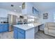 Well-lit kitchen featuring stainless steel appliances, tiled backsplash, and bright blue cabinets at 4489 57Th N Ave, St Petersburg, FL 33714