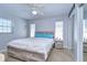 Light-filled main bedroom with a rustic wood bed frame, ensuite bathroom, and lots of natural light at 4489 57Th N Ave, St Petersburg, FL 33714