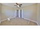 Spacious bedroom with tiled floors and ceiling fan, leading to closet and doorway at 473 Fairfax Ln, Apollo Beach, FL 33572