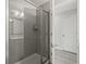 Modern bathroom featuring glass shower enclosure, neutral gray tile and fixtures at 5120 Bridge St # 6, Tampa, FL 33611