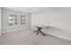 Bright bedroom with two windows, ceiling fan, neutral carpet, and gray desk at 5120 Bridge St # 6, Tampa, FL 33611