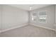 Neutral bedroom features carpeting, two windows, and lots of natural light at 5120 Bridge St # 6, Tampa, FL 33611