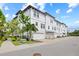 A row of townhomes with white exteriors, garages, and neat landscaping at 5120 Bridge St # 6, Tampa, FL 33611