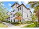 Beautiful three-story condo with manicured landscaping, showcasing its architectural details and curb appeal at 5120 Bridge St # 6, Tampa, FL 33611