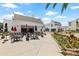 Charming outdoor dining with patio seating surrounded by lush landscaping under a bright sky at 5120 Bridge St # 6, Tampa, FL 33611