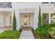 Charming condo front entrance with decorative plants and a welcoming door mat at address 5120 at 5120 Bridge St # 6, Tampa, FL 33611
