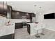 Modern kitchen featuring dark wood cabinetry, stainless steel appliances, and sleek white countertops at 5120 Bridge St # 6, Tampa, FL 33611