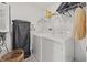 Clean laundry room with a washer, dryer, storage shelves, and organization at 5120 Bridge St # 6, Tampa, FL 33611